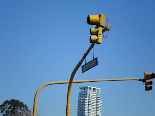 A Low Angle Shot of a Traffic Lights Under the Blue Sky