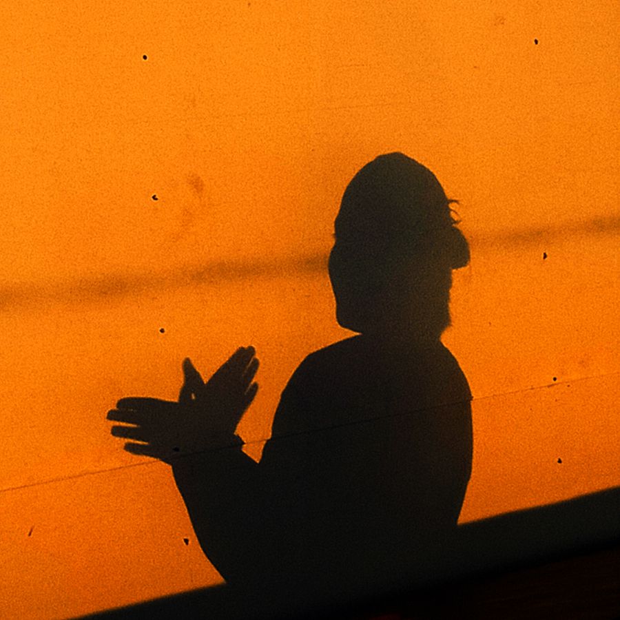 Shadow of a figure cast on a warm orange wall — Sheila Mae Yap on Pexels