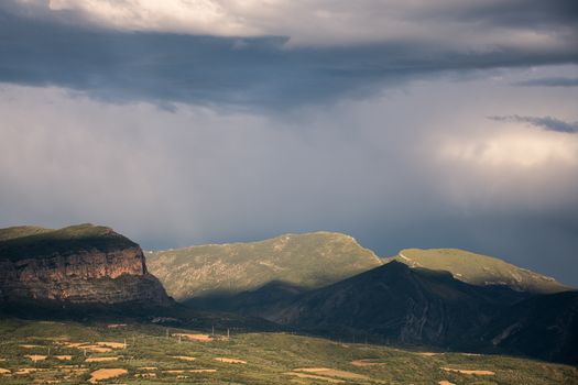 Scenic mountain landscape in Torallola, Spain with dramatic clouds.