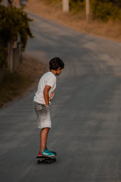 A Young Boy Skating on the Street