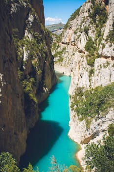 A breathtaking view of turquoise river winding through a dramatic canyon in Lleida, Spain.