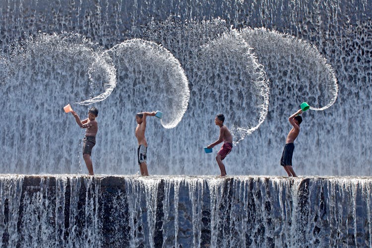 Boys Playing On The Spillway