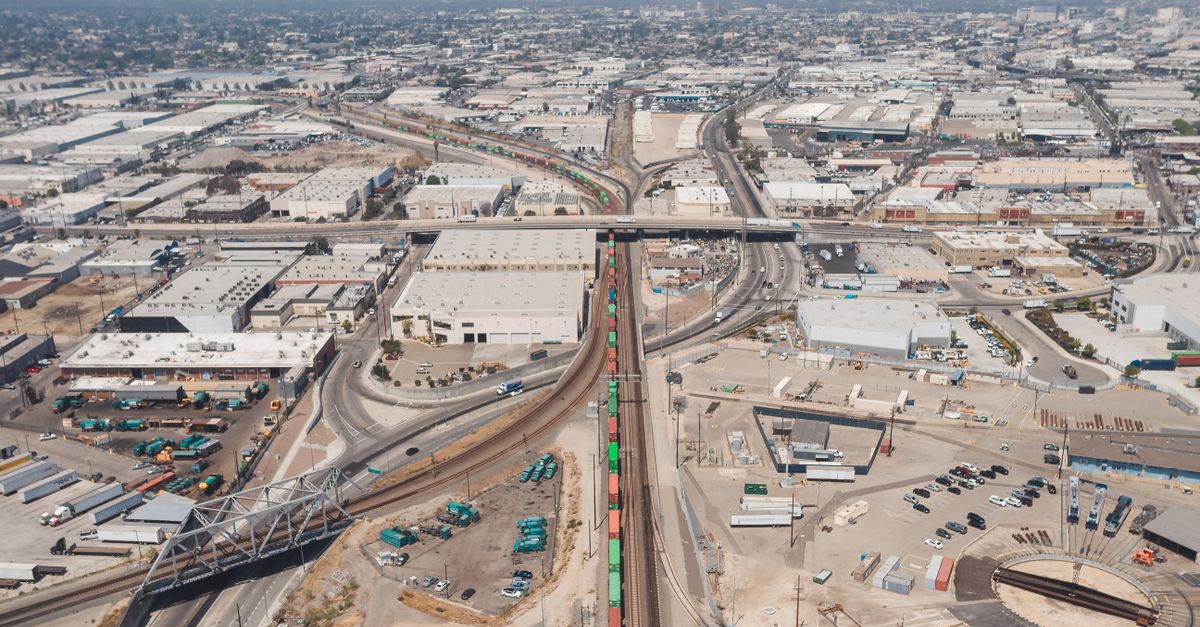 Aerial shot showcasing an industrial district with railways, roads, and modern infrastructure.