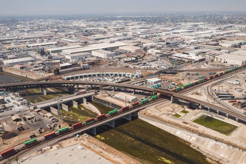 Free Drone shot of Los Angeles showcasing urban railways and expansive industrial area. Stock Photo