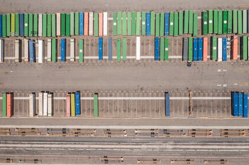 Free A birds-eye view of colorful shipping containers at a railway logistics yard. Stock Photo