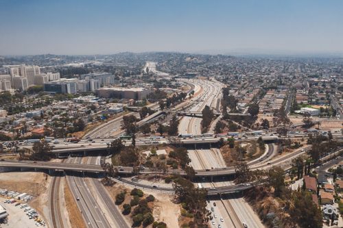 Free Aerial view of complex highway intersections in Los Angeles showcasing city infrastructure and urban landscape. Stock Photo