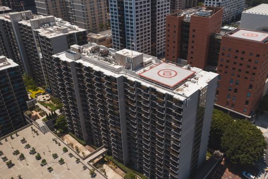Aerial drone shot showcasing modern high-rise buildings in a metropolitan setting during the day.