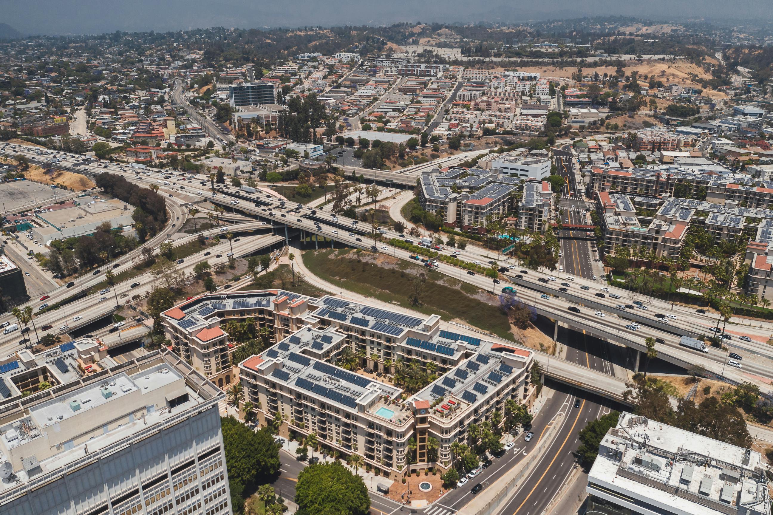 an aerial shot of buildings and highways in a city