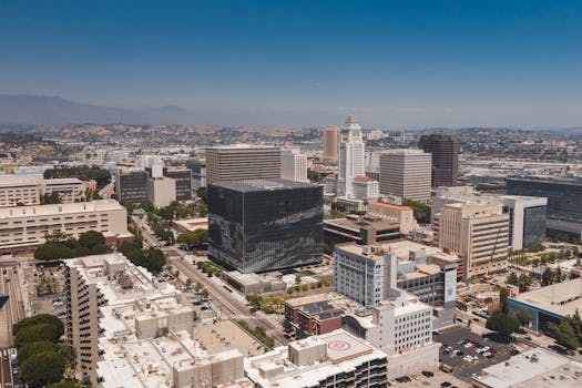 Stunning aerial view of Los Angeles cityscape with modern skyscrapers and blue skies.