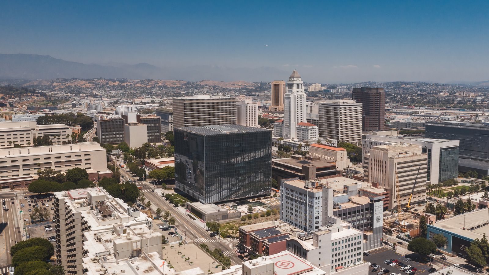 Stunning aerial view of Los Angeles cityscape with modern skyscrapers and blue skies.