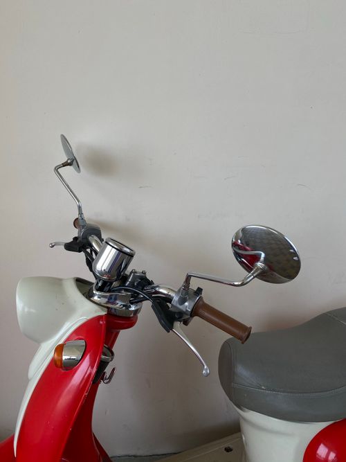 Free Close-up of a vintage red and white motor scooter parked indoors. Stock Photo