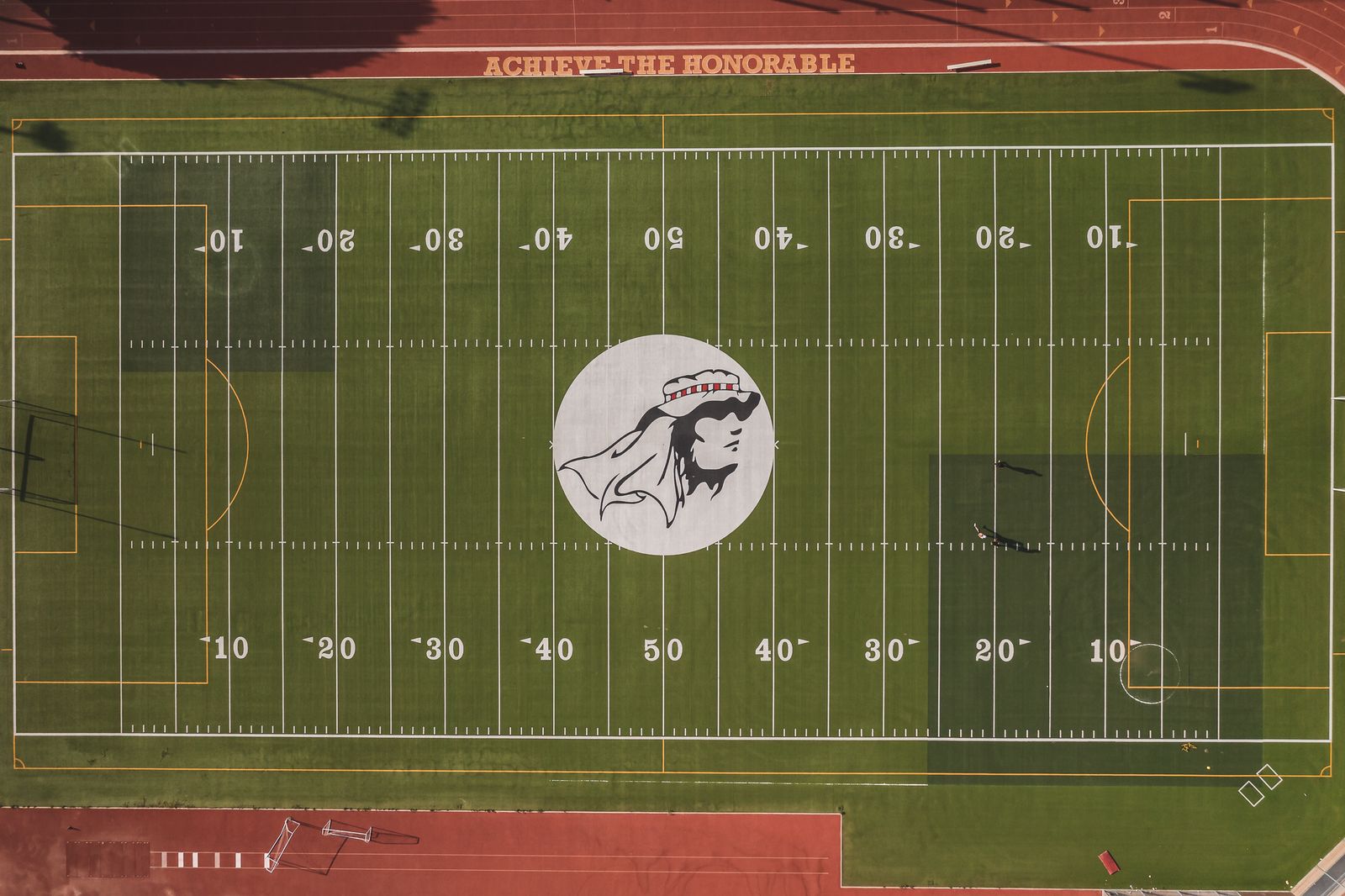 Aerial view of an empty sports field with track and field markings