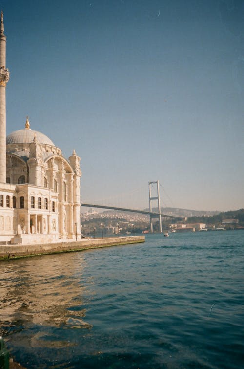 White Concrete Building Near Body of Water