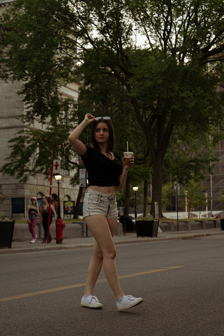 Woman Wearing Shorts While Walking On The Street