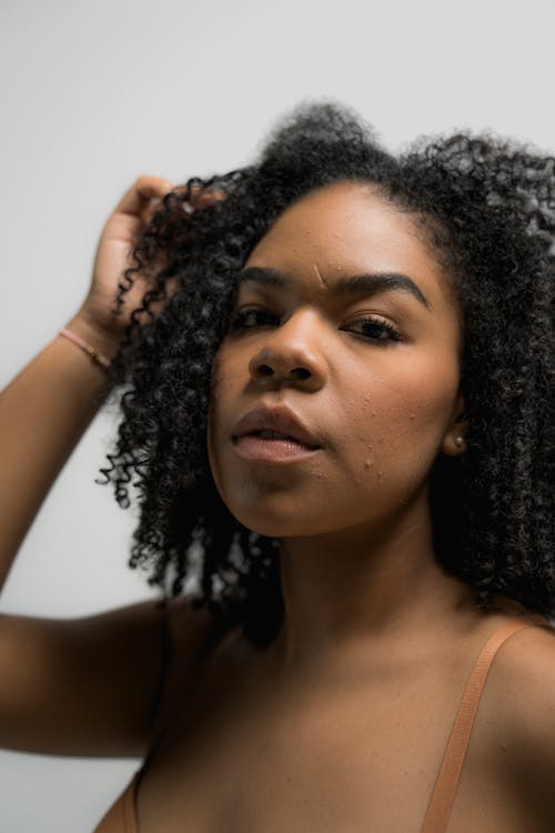 Free Woman in Brown Bra with Hand on Head Stock Photo