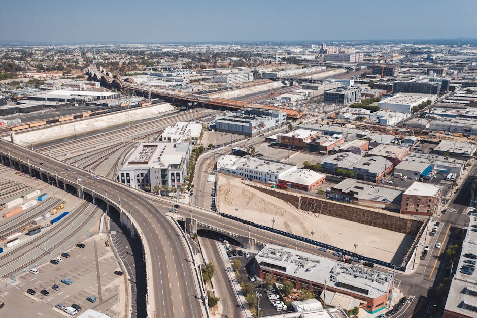 High-angle view of a sprawling urban landscape with highways and train tracks.