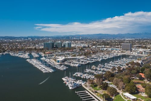 Free Stunning aerial photograph of Marina Del Rey showcasing boats and city skyline under a clear blue sky. Stock Photo