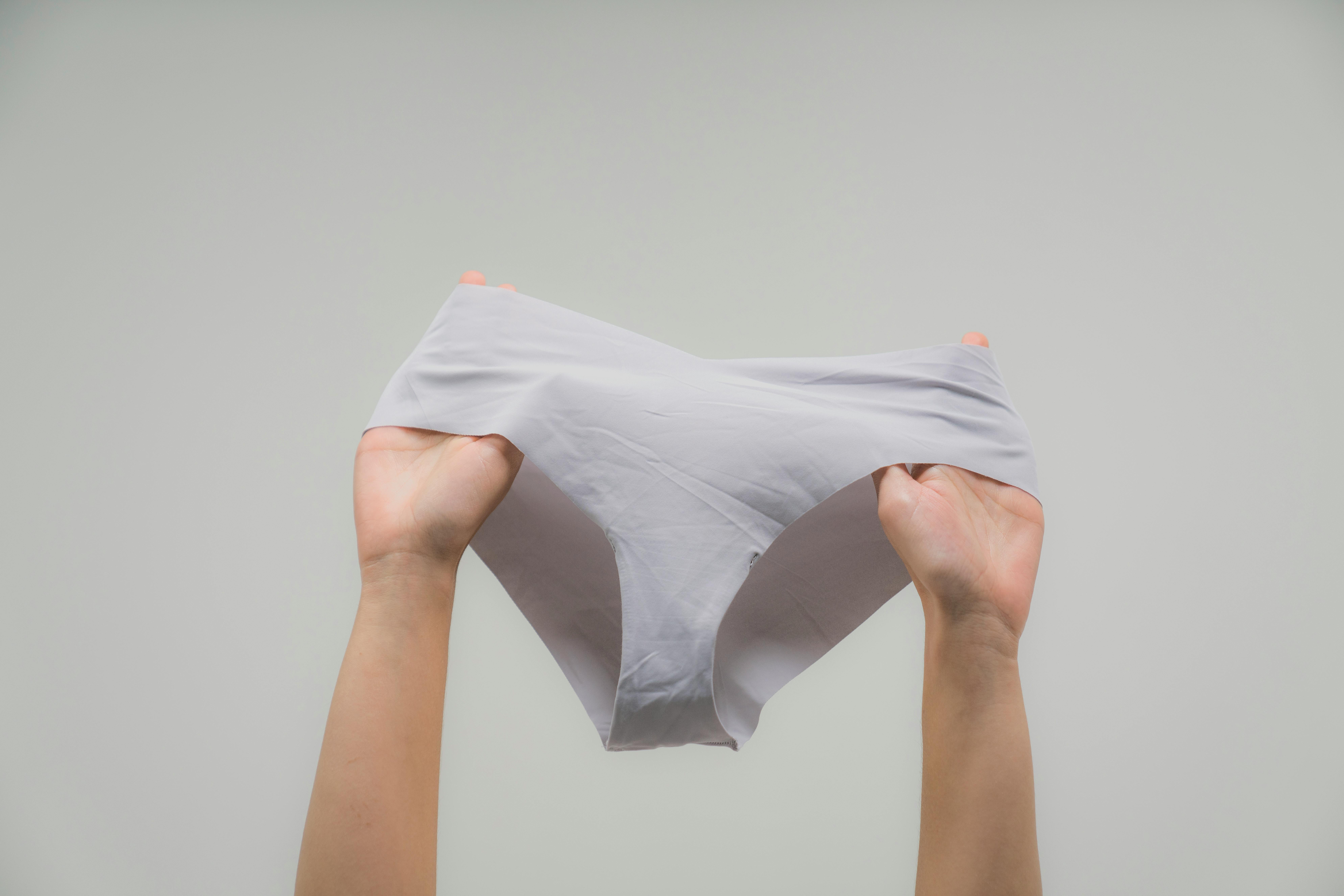 Close-Up Shot of a Woman Holding Her Underwear on White Background · Free  Stock Photo