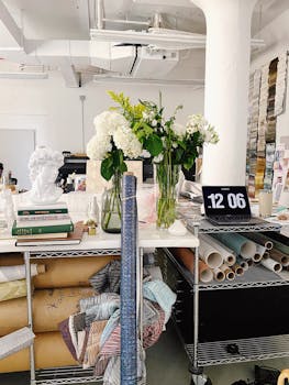 A vibrant art studio in New York City featuring floral arrangements and art supplies.