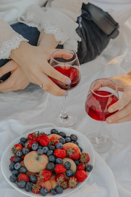 Hands Holding Wine Glasses