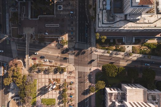 Stunning aerial shot of a city intersection captured during summer, showcasing urban life from above.