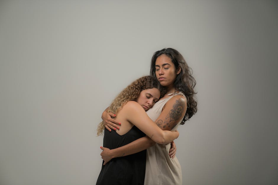 Two women share a comforting embrace, symbolizing support and togetherness.