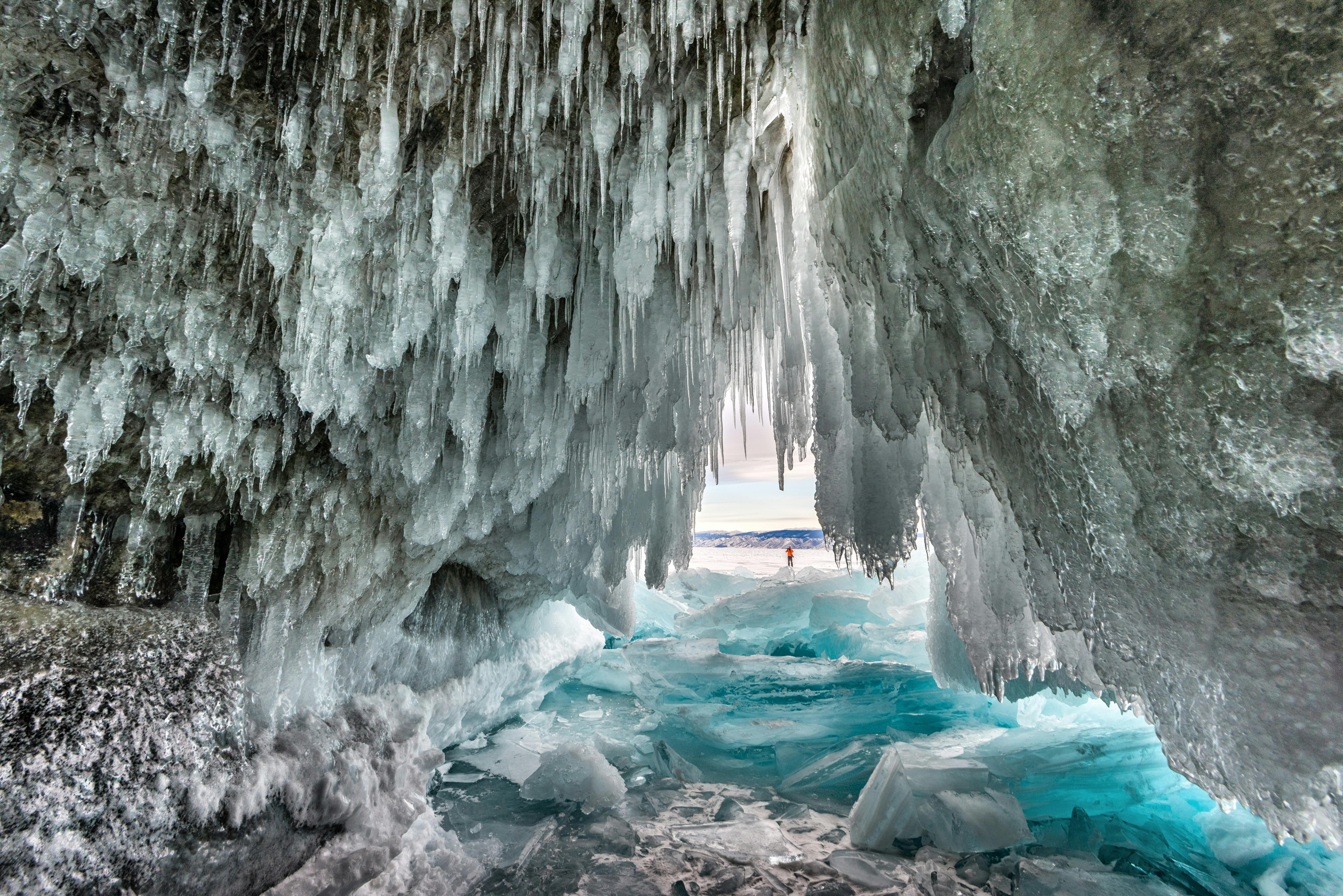 Breathtaking view inside a frozen ice cave in Siberia, showcasing stunning stalactites and icy formations.