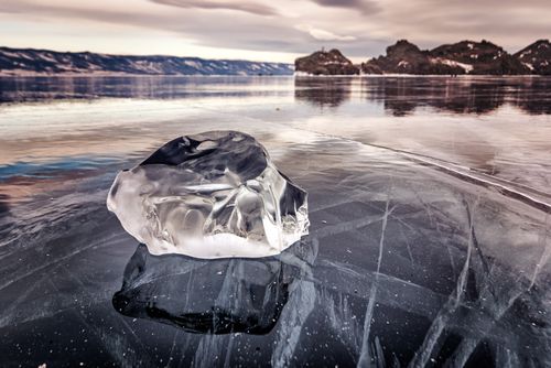 Free An ice block on the frozen surface of Lake Baikal, showcasing the winter landscape. Stock Photo