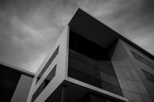 Free Grayscale Photo of Building With Glass Windows  Stock Photo