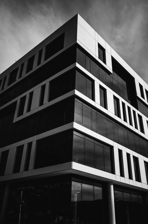 Free Striking low-angle shot of a modern building facade in monochrome. Stock Photo