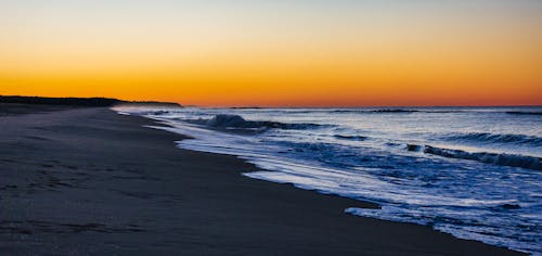 Ocean Waves Crashing on Shore during Sunset