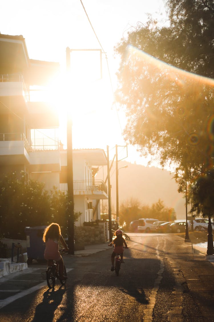 Girls Riding Bicycle On Street 