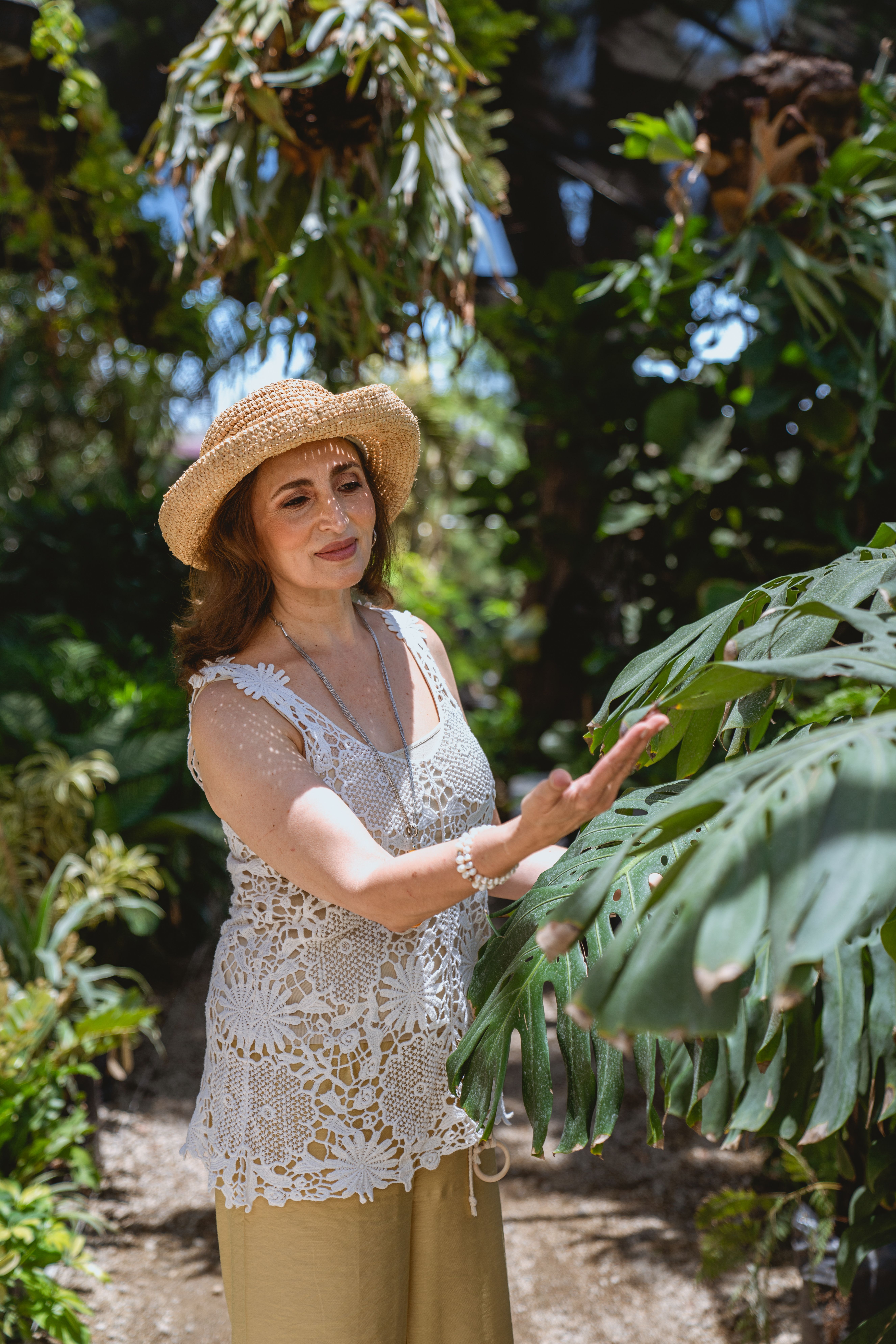 Woman in White Tank Top Holding Green Plants · Free Stock Photo