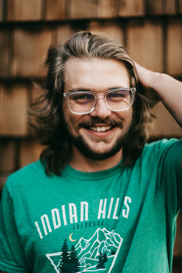 Man In Teal Shirt Wearing Sunglasses 