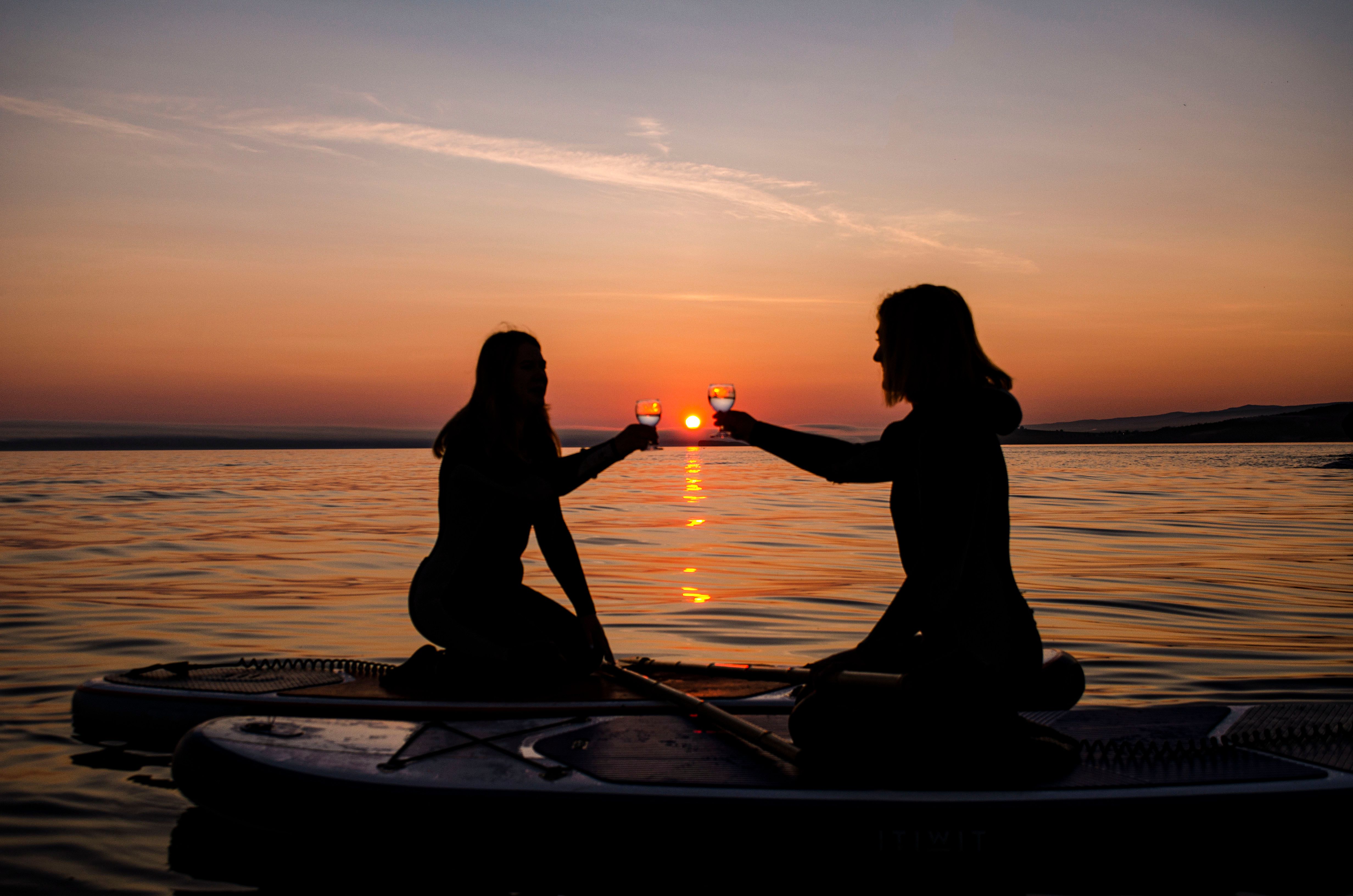 Silhouette of Couple on Boat at Sunset · Free Stock Photo