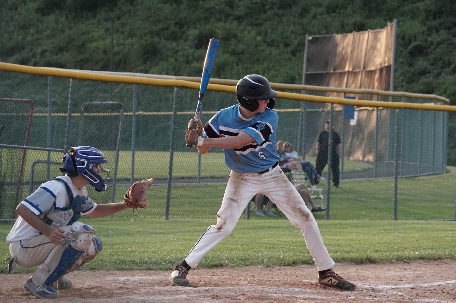Young baseball players in action during a sunny outdoor game.