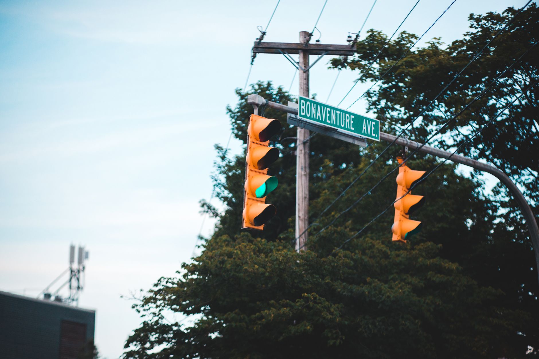 Close-up of a green traffic light at an intersection with street signs on Bonaventure Ave.