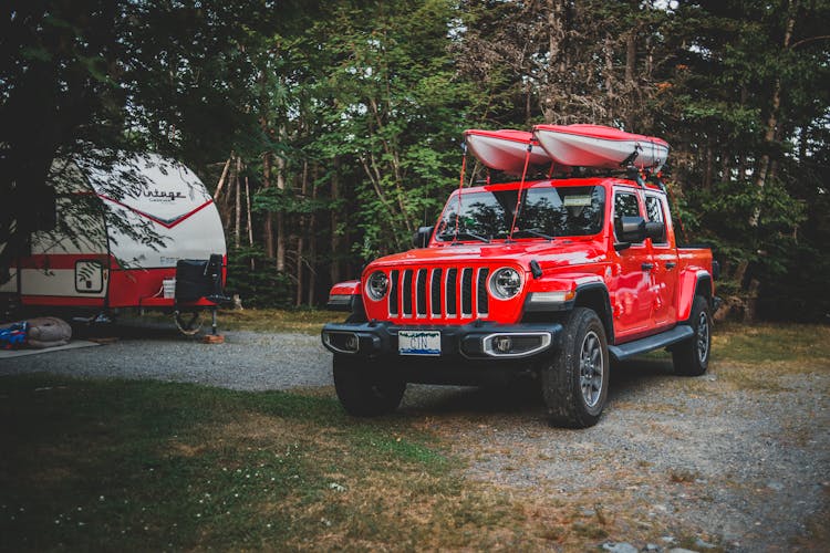 Truck With Kayaks On The Roof Parked On A Camping Site