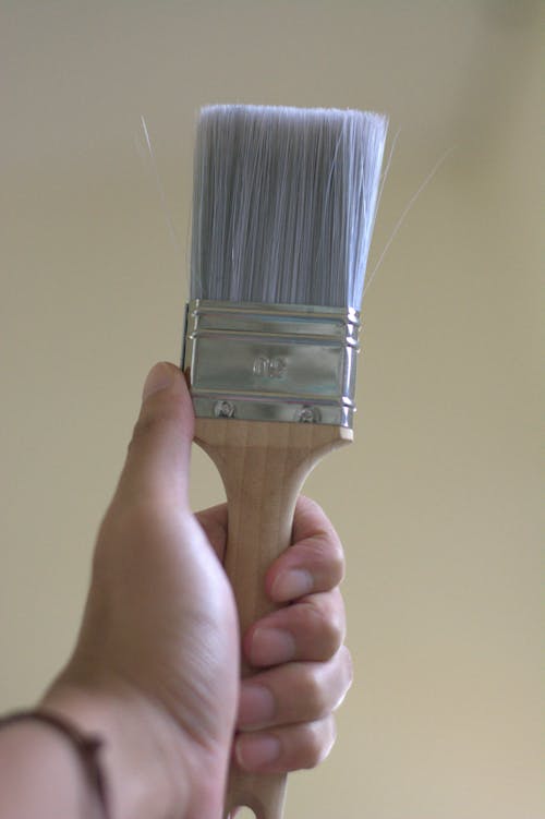 Free A Person Holding a Paintbrush  Stock Photo