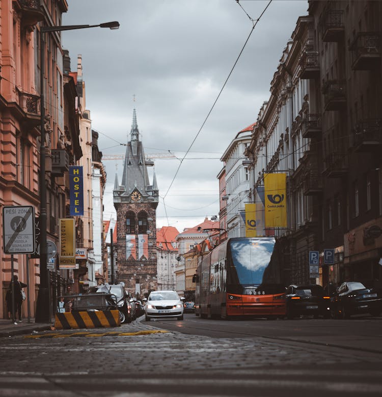 Low Angle Shot Of City Street With Traffic And Clock Tower In Perspective