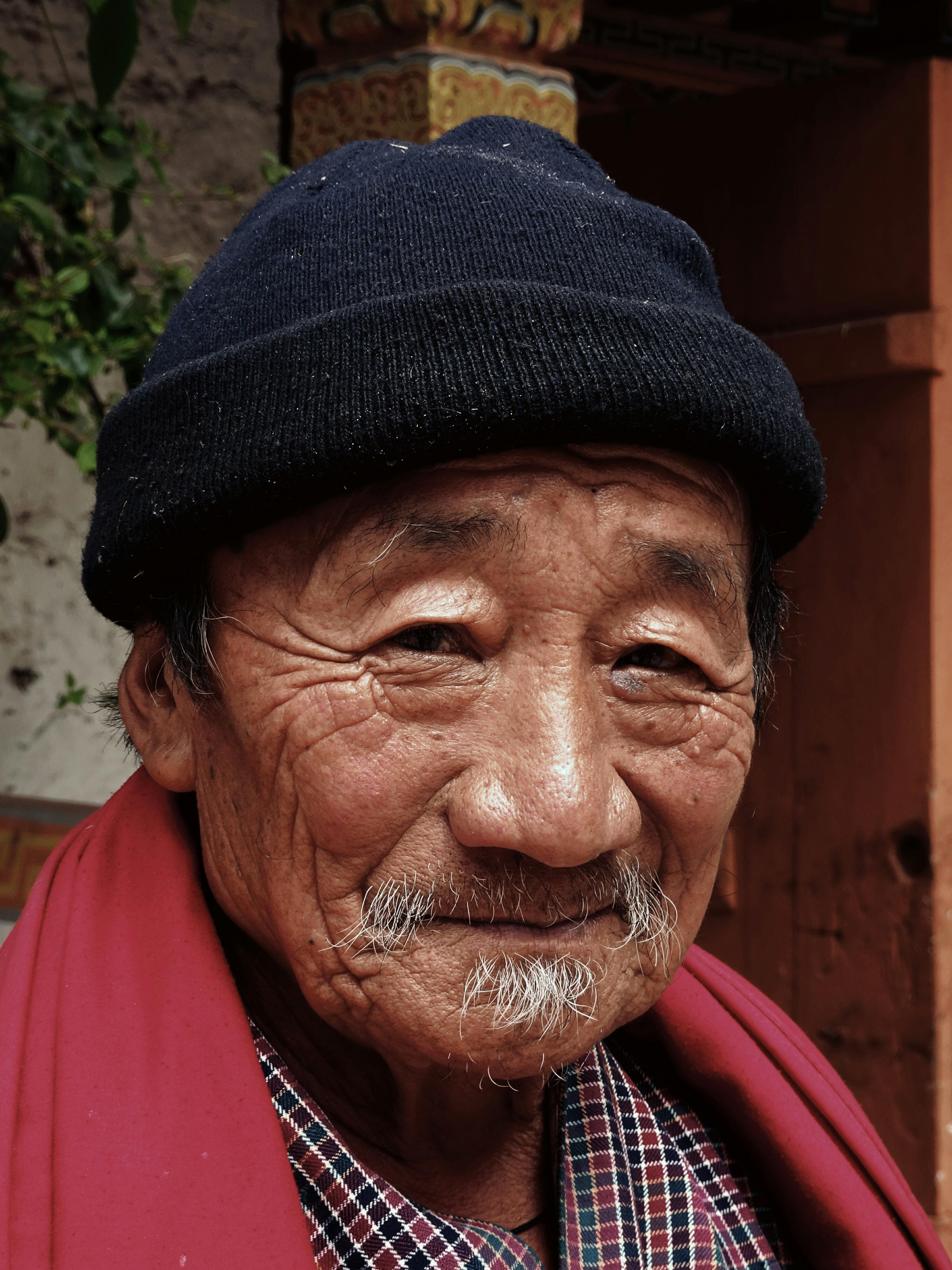 smiling man wearing red scarf and black beanie