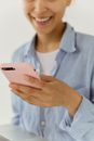 Close-Up Shot of a Person Smiling While Looking at the Cellphone