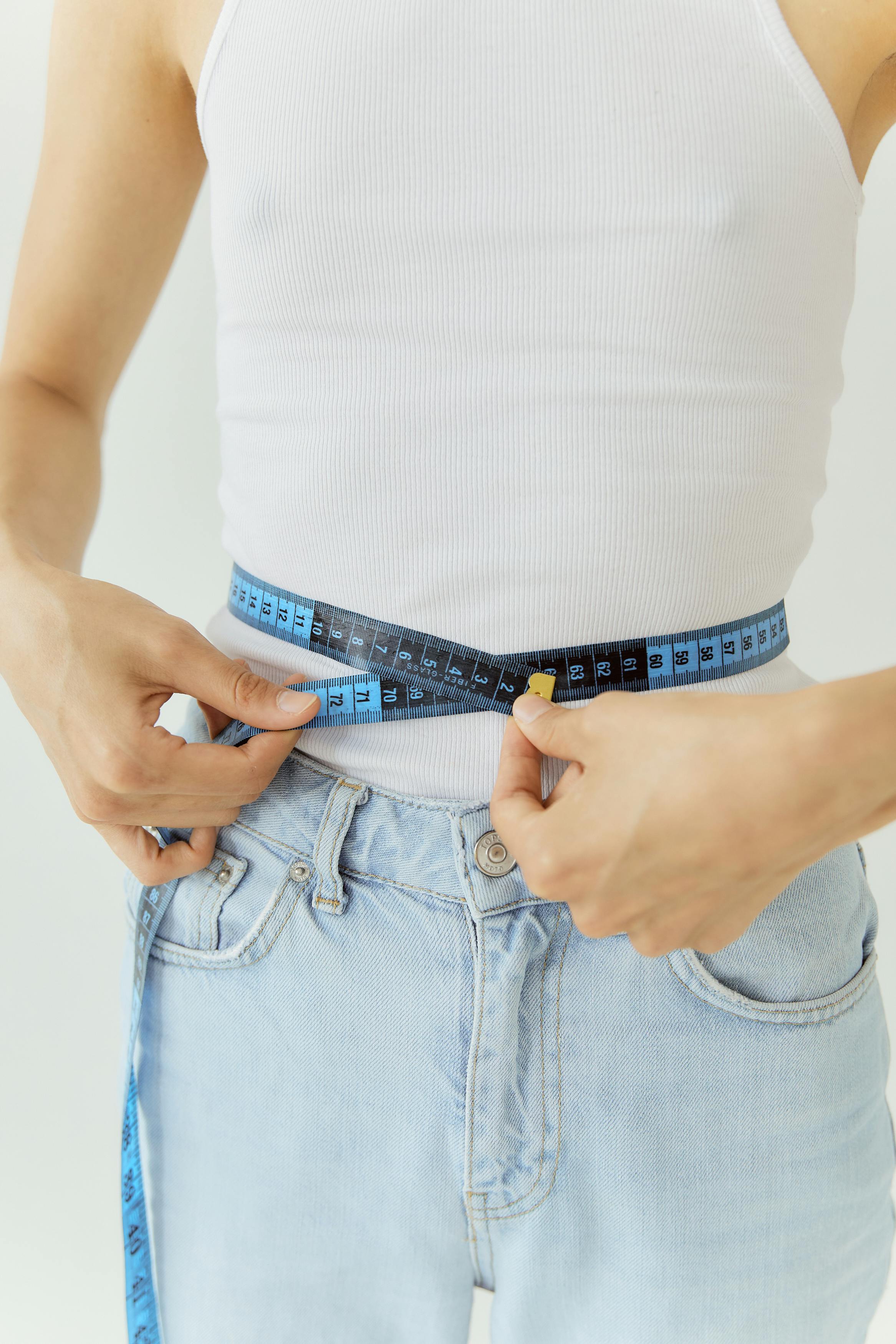 woman measuring her waist