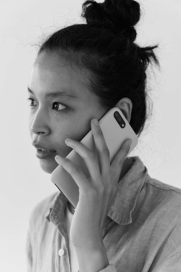 Grayscale Photo Of Woman Holding A Cellphone To Her Ear