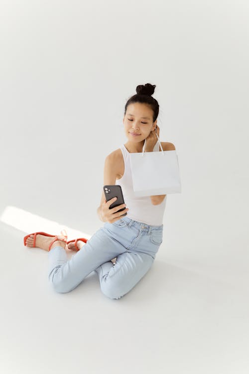 Woman Taking A Selfie While Holding a Shopping Bag