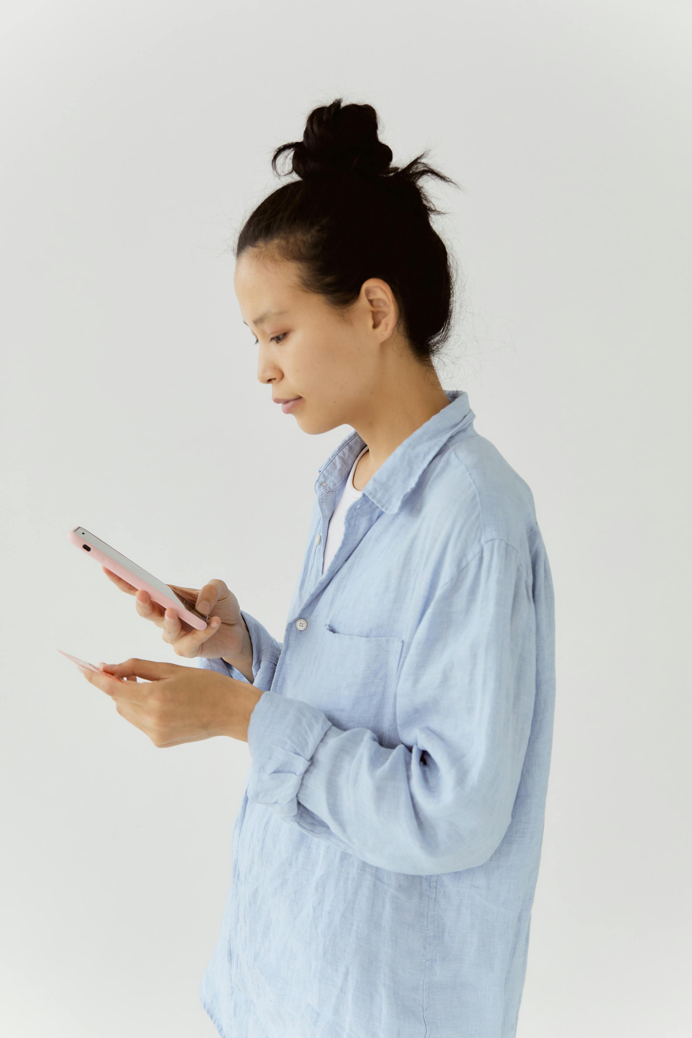 woman using her smartphone and holding her credit card