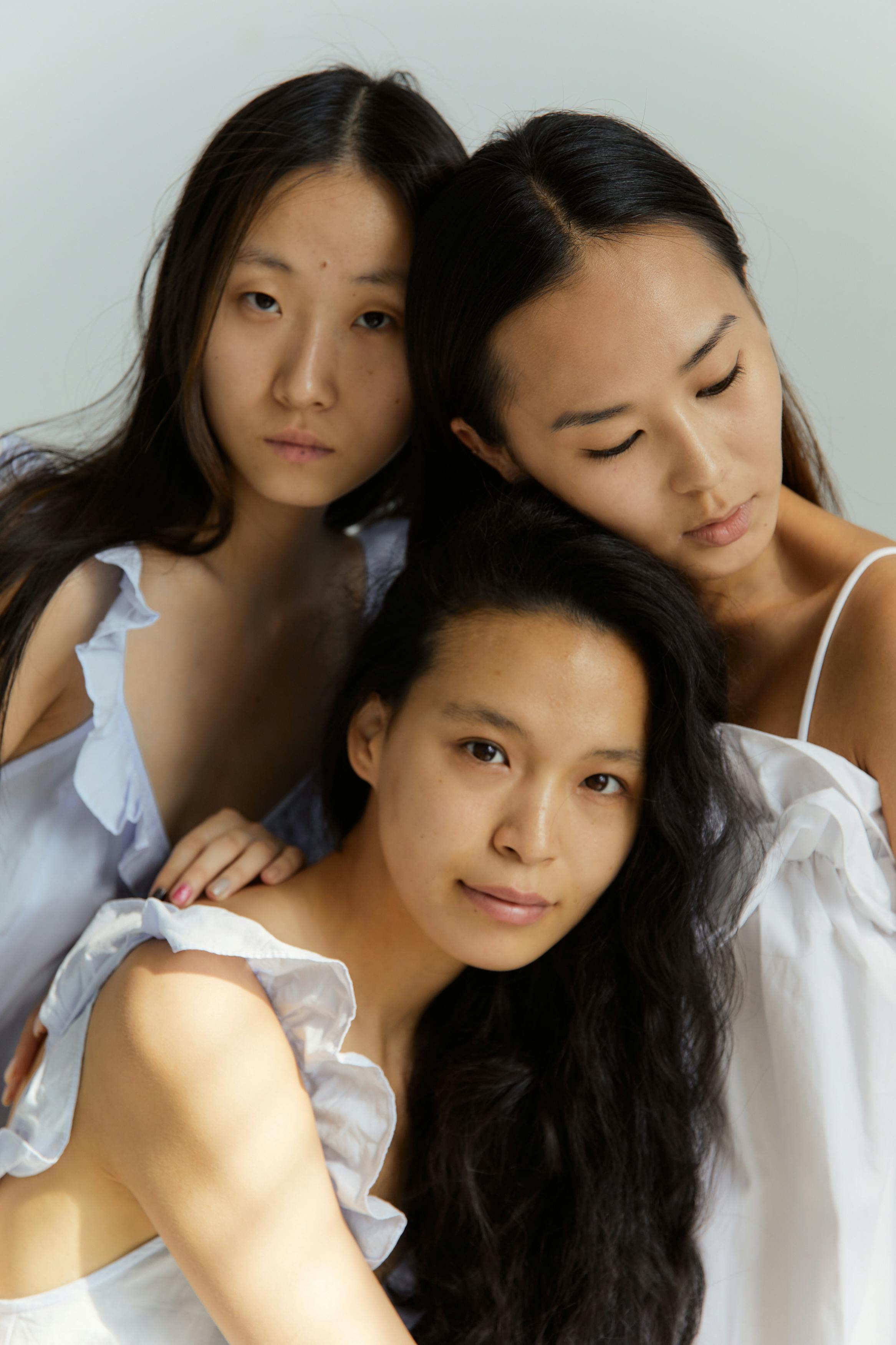 three woman in white dresses