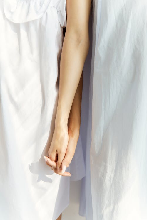 Close-Up Shot of Two People Holding Hands