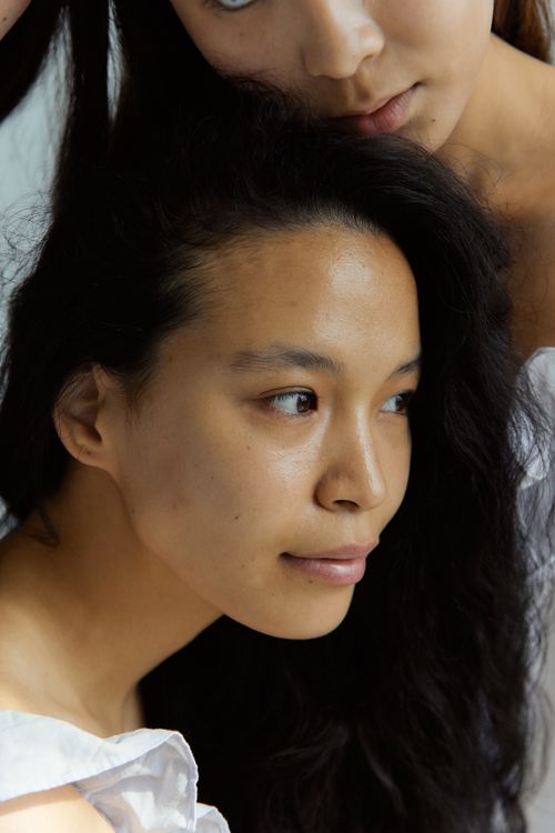 Free Intimate close-up of two women captured in soft natural light, highlighting serene expressions. Stock Photo
