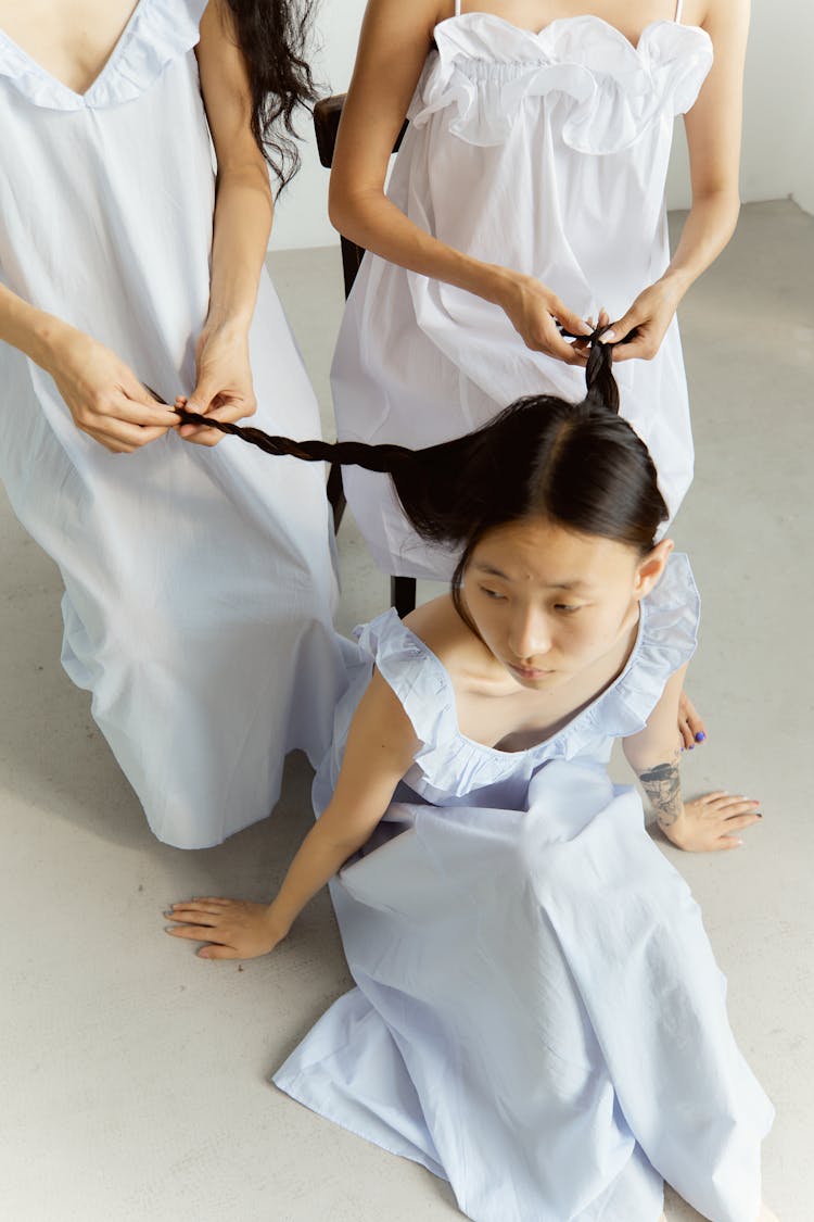 Women Weaving Braids For Asian Girlfriend